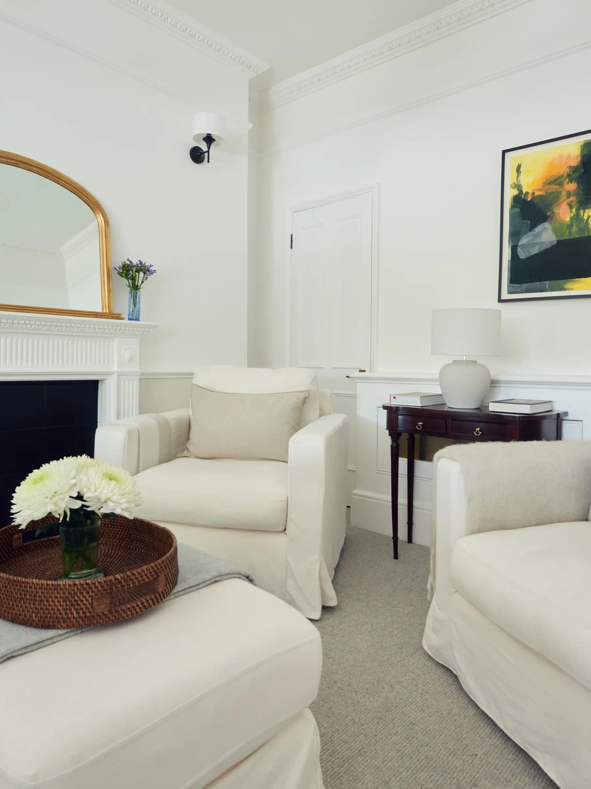 Room 2 — armchairs beside the fireplace and gilt arched mirror
